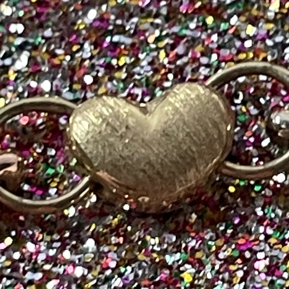 14K gold bracelet with little children on it.